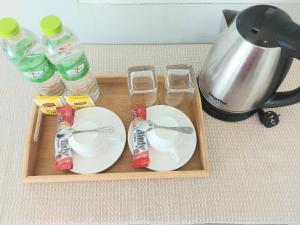a tray with two dishes and two bottles of water at Patrick villa phuket in Bang Tao Beach