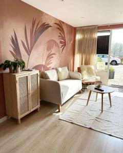 a living room with a couch and a table at Zwikker aan de Haven in Lelystad