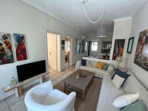a living room with a couch and a tv at The ART space in Kavala in Kavála