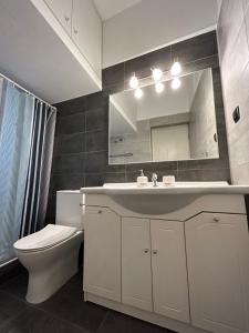 a bathroom with a sink and a toilet and a mirror at The ART space in Kavala in Kavála +16 photos