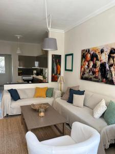 a living room with two couches and a table at The ART space in Kavala in Kavála