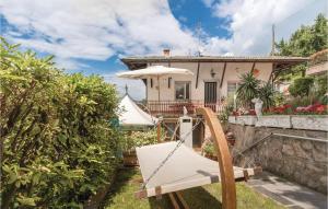 a villa with a boat in front of a house at App Heli in San Zeno di Montagna