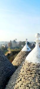 two towers on top of a stone wall at Trulli Nuova Aia Resort in Alberobello