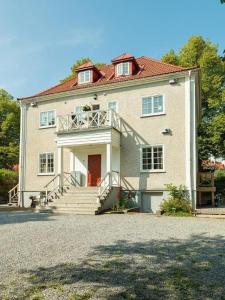 a large white house with stairs and a porch at Beautiful and modern accommodation near Stockholm City in Stockholm