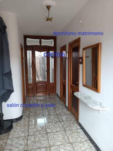 a room with wooden doors and a tile floor at APARTAMENTOS OUTEIRO in A Pobra do Caramiñal