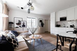 a living room with a couch and a table at Beautiful and modern accommodation near Stockholm City in Stockholm