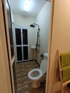 a bathroom with a toilet and a sink at Chalet Terapung Laman Tok Ayah Temerloh in Temerloh