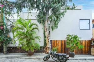 a motorcycle parked in front of a building at The Eucalyptus Mansion by HolyGuest in Tel Aviv