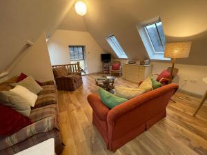 a living room with two couches and a table at Lochhournhead B&B & Tea Room in Invergarry