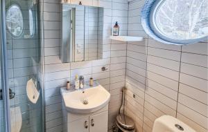 a bathroom with a sink and a mirror at Stunning Apartment In Marstrand With Kitchen in Marstrand