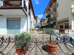 a wrought iron fence with potted plants in a courtyard at casa bob alloggio turistico in Fondi
