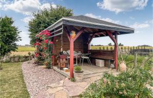a wooden gazebo with a table in a garden at Nice Apartment In Østermarie With Wifi in Østermarie +15 photos