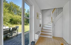 a room with a staircase and a dining room with a window at Nice Home In Tim With Kitchen in Tim +15 photos