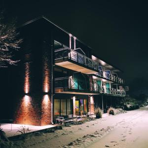 a building on the beach in the snow at night at Just Eleven in Sankt Peter-Ording