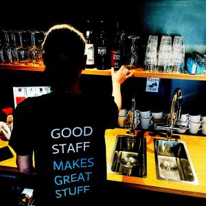 a person standing at a counter in a bar at Just Eleven in Sankt Peter-Ording