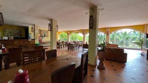 a dining room with a table and some chairs at Centro Bajo Hotel & Resto in Labuan Bajo