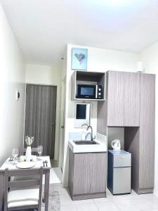 a small kitchen with a sink and a microwave at Urban Nest PH in Manila