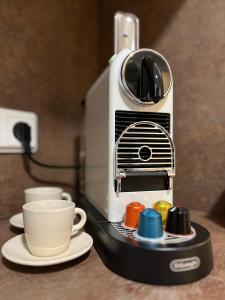 a coffee maker with a cup on a counter at S.F.C. Apartments in Trier