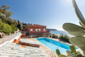 a house with a swimming pool and a cactus at GOLFE BLEU - Havre de paix en bord de plage in Roquebrune-Cap-Martin