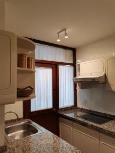 a kitchen with a sink and a counter top at Casa Blikstad, Con Wifi y Garaje · 3 hab - 6 pax in Gijón