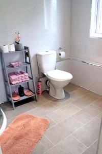 a bathroom with a white toilet and a towel at The Cabin in Bonnybridge