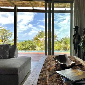 a living room with a couch and a large window at VillaTwo@Tsai-Tsai in Vilanculos