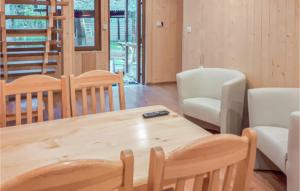 a dining room with a wooden table and chairs at Awesome Home In Debki With Wifi in Dębki