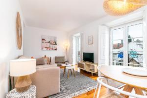 uma sala de estar com um sofá e uma mesa em Gonzalos's Guest Apartments - Alfama Terrace em Lisboa