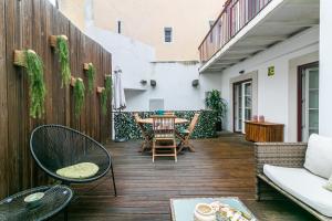 an outdoor patio with a table and chairs at Gonzalos's Guest Apartments - Alfama Terrace in Lisbon
