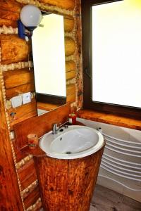 a bathroom with a wooden sink and a mirror at Domek u Johnnego 27 
