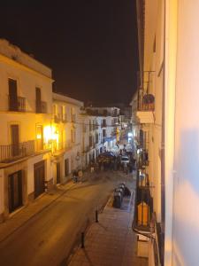 uitzicht op een straat 's nachts met gebouwen bij Habitaciones La Flamenka in Ronda