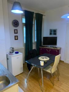 a living room with a table and a kitchen at Apartment Rose II in Zagreb