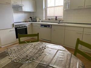 a kitchen with a wooden table and a kitchen with a boat on it at Wohnung an der Mühle in Eystrup
