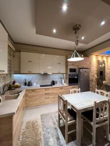 a kitchen with a table and a kitchen with a sink at Corner House Volos in Volos