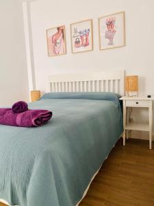 a bedroom with a bed with a blue blanket on it at Bonito Apartamento Conil CALEFACCIÓN Y WIFI -SOLO FAMILIAS Y PAREJAS- in Conil de la Frontera