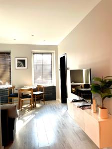 a living room with a table and a television at Apartament Kaja in Siemianowice Śląskie
