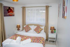 a bedroom with a bed and a window at 16 Arabella Residence near Waterfront Mall - Karen in Karen