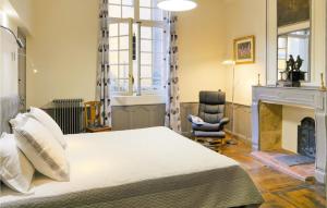 a bedroom with a bed and a fireplace at La Labrousse in Sarlat-la-Canéda