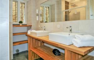 a bathroom with two sinks and a mirror at La Labrousse in Sarlat-la-Canéda