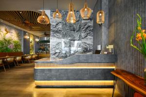 a restaurant with a tub in the middle of a room at La Opera Saigon Hotel in Ho Chi Minh City