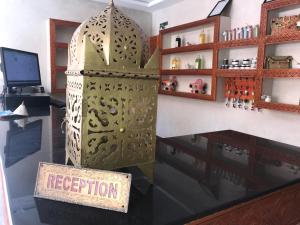 a shop display with a large metal door and a sign at Les Bains de Mirleft in Mirleft