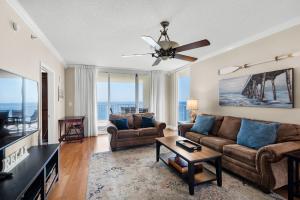 a living room with a couch and a ceiling fan at Majestic Beach Towers 1-1701 in Panama City Beach