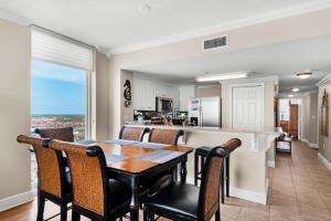 a kitchen and dining room with a table and chairs at Majestic Beach Towers 1-1701 in Panama City Beach
