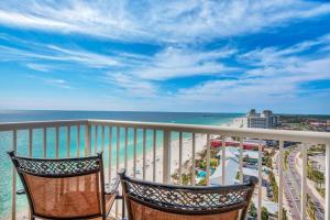 two chairs sitting on a balcony overlooking the ocean at Majestic Beach Towers 1-1701 in Panama City Beach