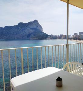 a balcony with a table and a view of the ocean at Ca Vicent in Calpe
