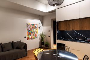 a living room with a couch and a table at Suite Carolina HOME SUITE HOME in Pescara