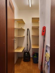 a room with a closet with shelves and a vacuum at Gästehaus am Weser-Radweg in Hannoversch Münden
