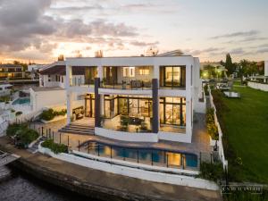 an aerial view of a house with a river at stunning prestige residence in Gold Coast