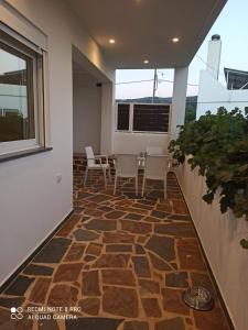 a room with a patio with chairs and a table at Vineyard of Valta in Marmari +7 photos