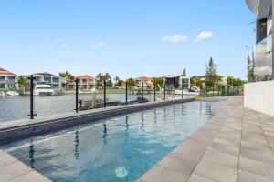 a swimming pool in the middle of a building with water at stunning prestige residence in Gold Coast